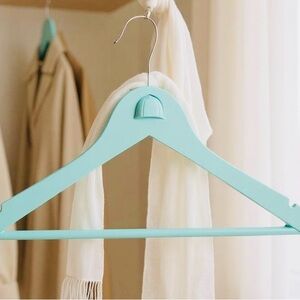 Teal Hanger with Angled Shoulders for the Equestrian attire adorned with helmet.